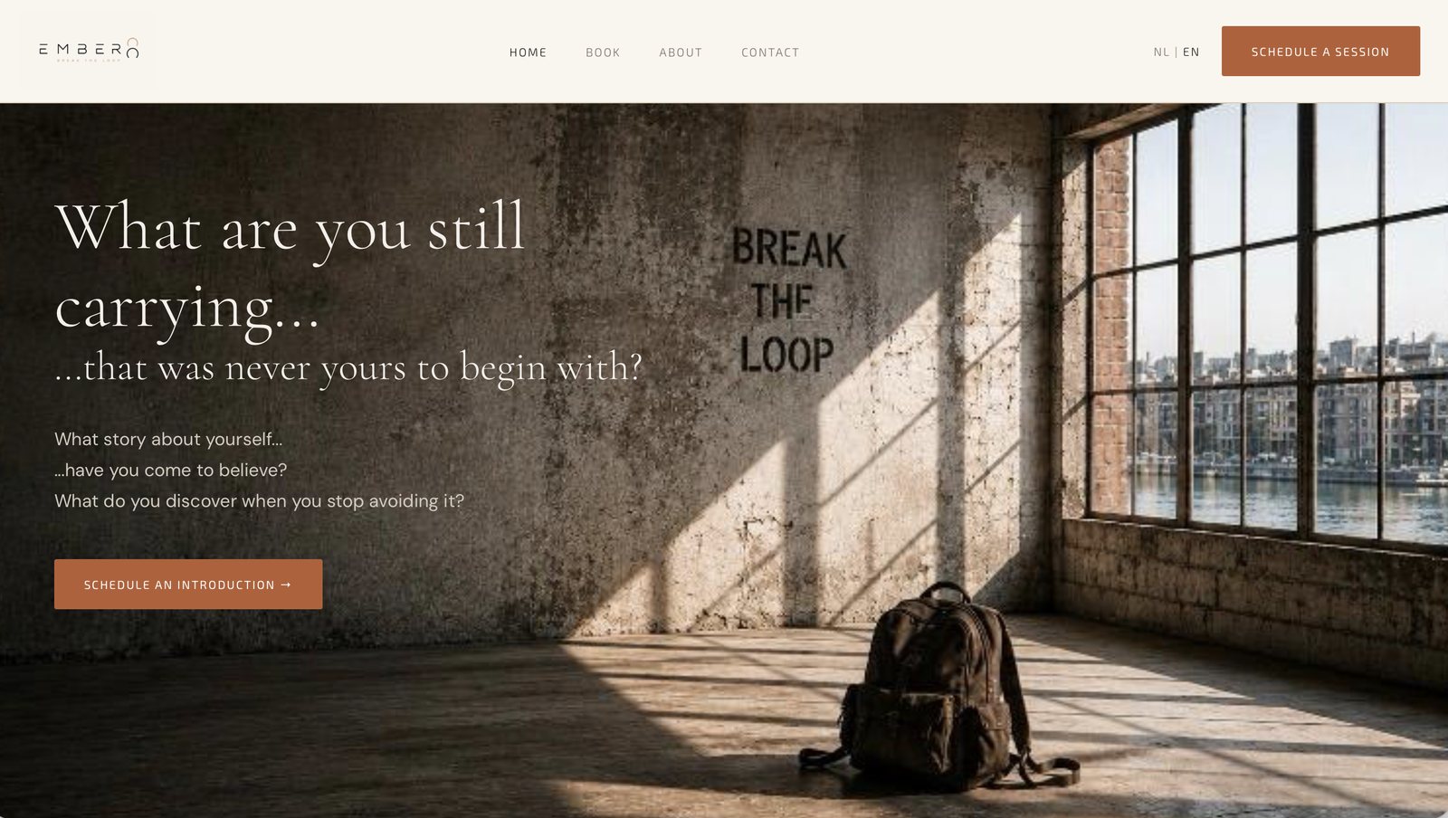 The Ember8 home page: a bare concrete room with BREAK THE LOOP stencilled on the wall, and the headline &ldquo;What are you still carrying&hellip;&rdquo;